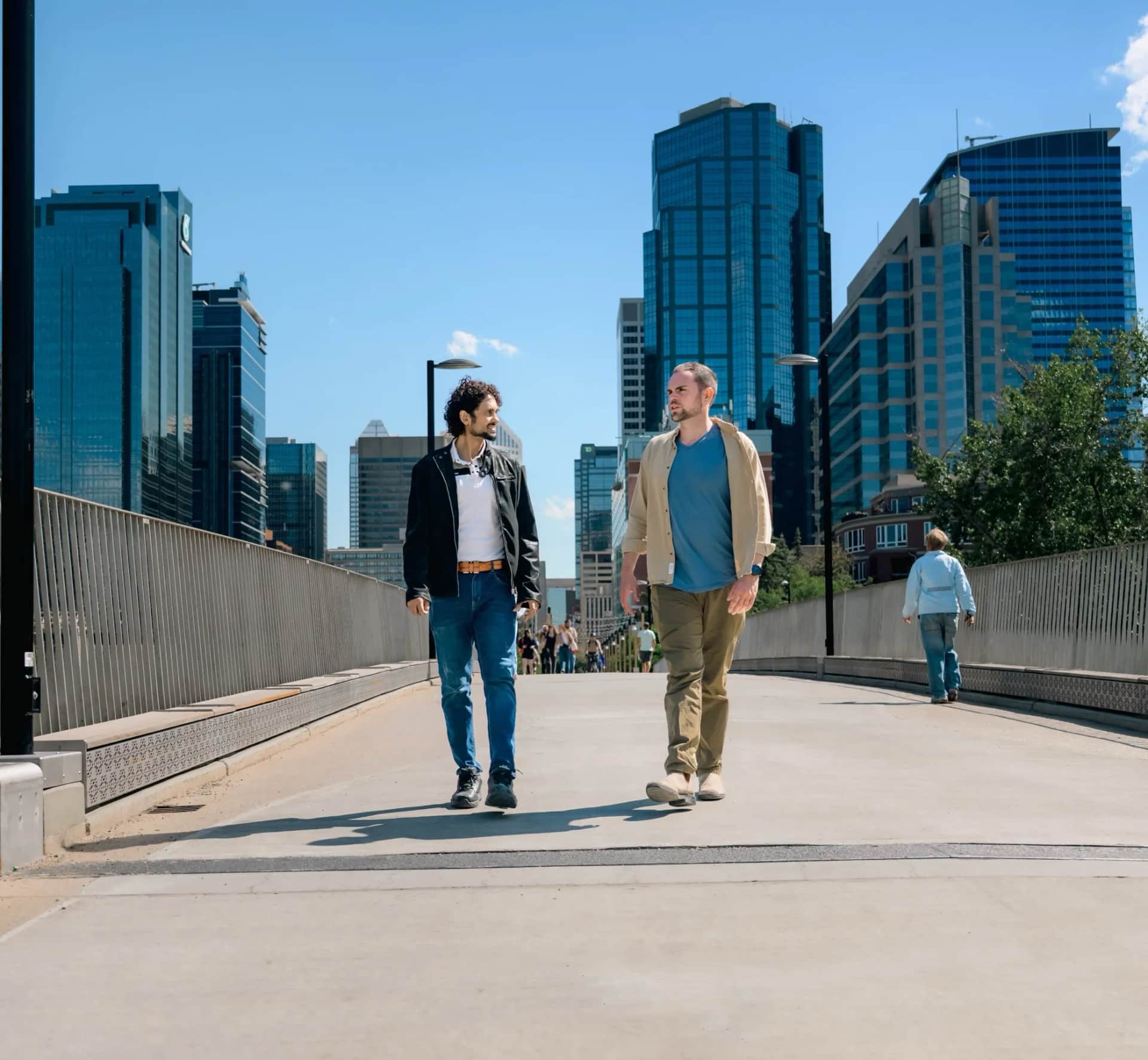 Two people in conversation while walking through downtown Calgary