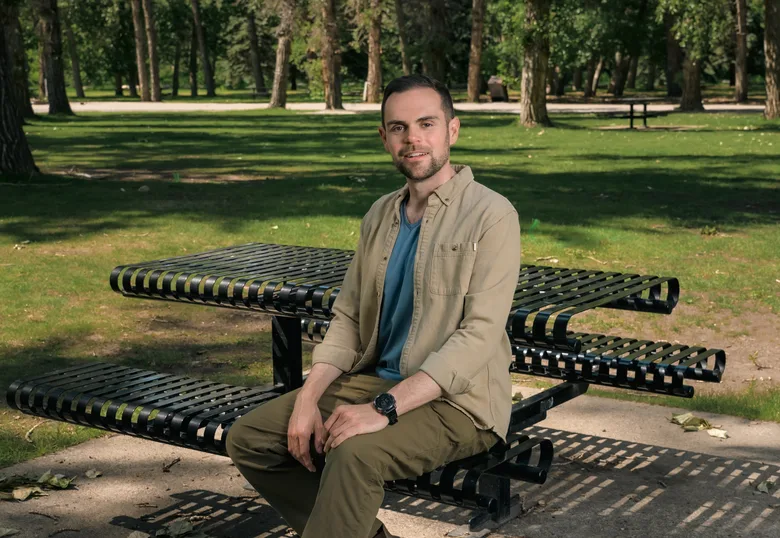 Michael Snow sitting on a park bench in Calgary